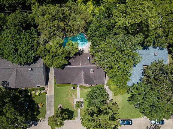 Surrounded by mature trees this wooded lot with a POOL backs to the RAVINE and has no back neighbors. NEVER FLOODED!