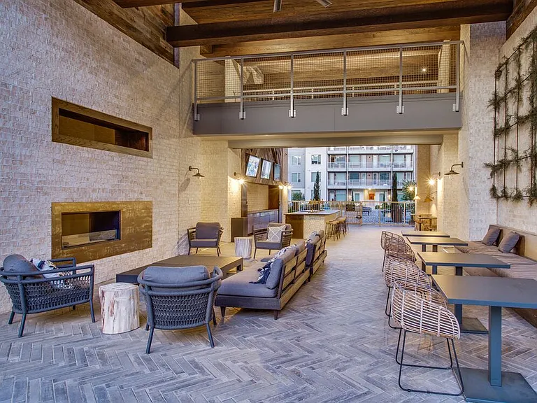 Outdoor lounge area with seating and fireplace