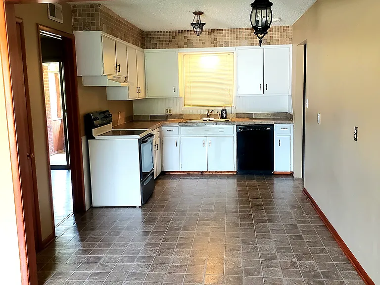 Roomy kitchen area! Electric Range and Dishwasher. Room for a dinette set!