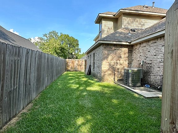 Private fenced side yard with doggy door access