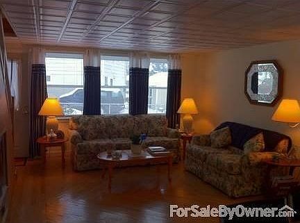 Living Room with furnishings
						:
						Replacement windows throughout. Lots of light.