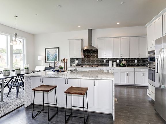 Well-appointed Kitchen with Granite Countertops and an Abundance of Cabinets