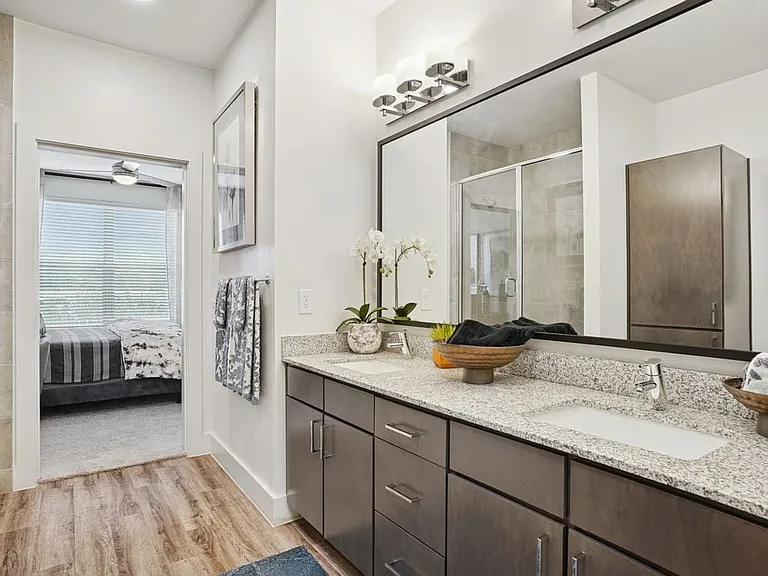 Bath with espresso cabinetry, speckled granite countertops, and hard surface flooring