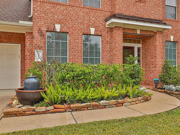 The landscaping is well manicured in the front and back yards.