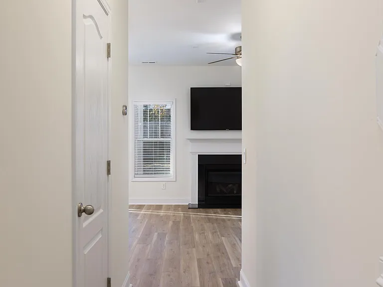 Entry w/powder room leads to living room.
