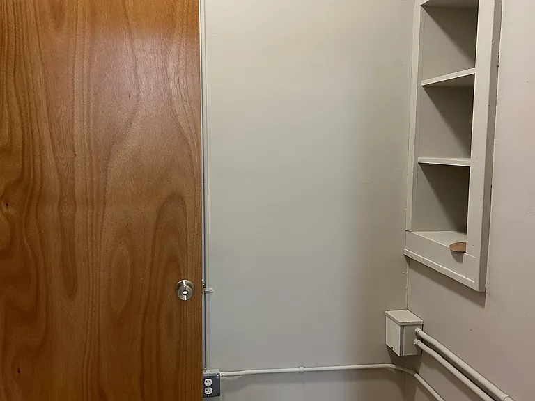After entering, there is a small mudroom area with storage cupboards and outlets.