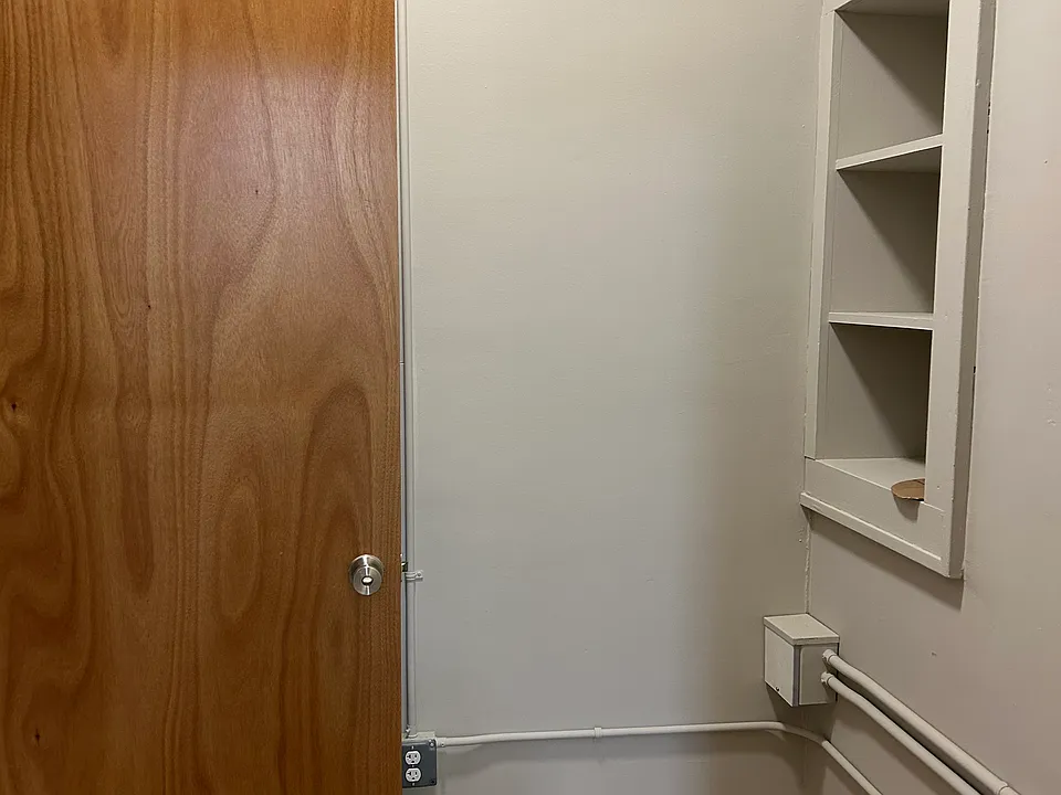 After entering, there is a small mudroom area with storage cupboards and outlets.