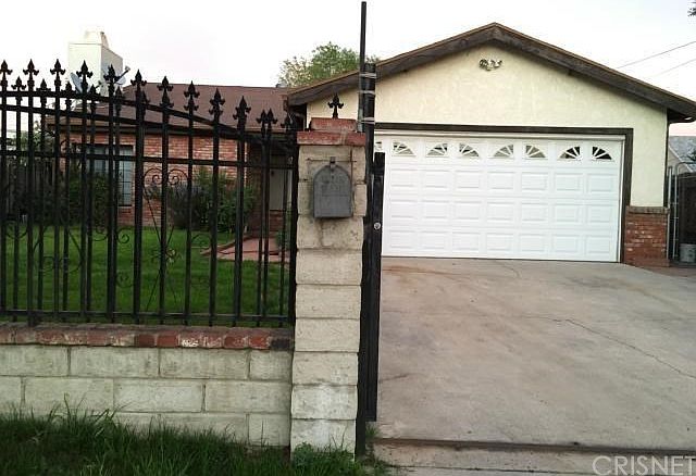 Front view of home outside of gate.