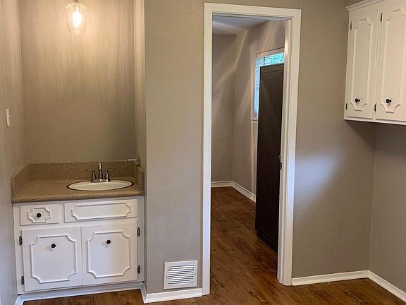 Utility room with sink, washer dryer hook ups, and 4th room for office or additional bedroom.