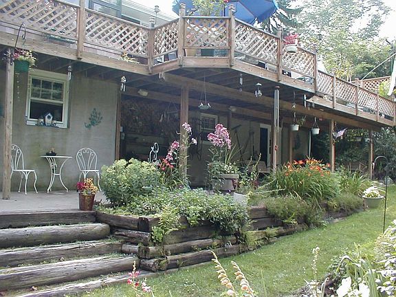 Huge Deck across rear overlooking perrenial gardens