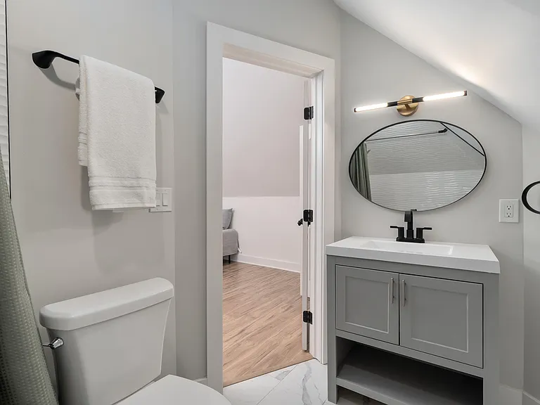 Updated bathroom with a wide vanity, modern fixtures, and convenient towel storage for daily routines.