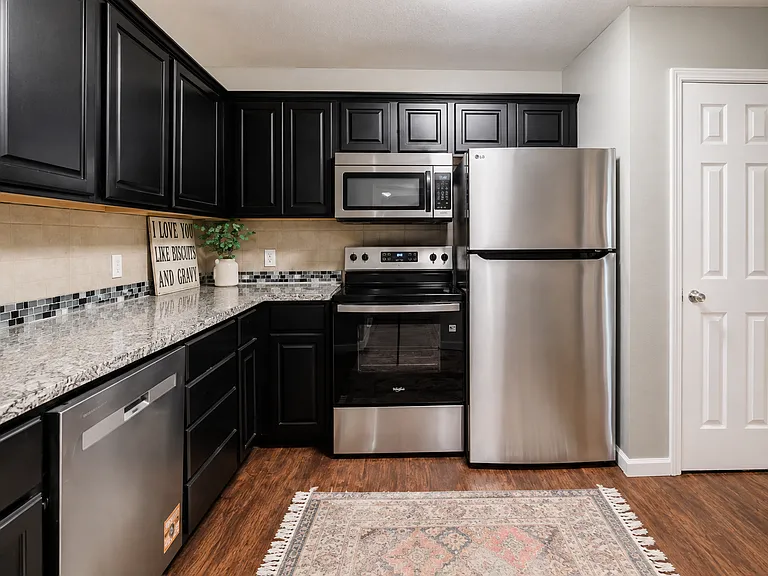 Fully Equipped Kitchen _ Featuring stainless steel appliances, including a refrigerator, electric range, microwave, and dishwasher, plus generous granite countertops and abundant cabinet space for convenient everyday cooking.