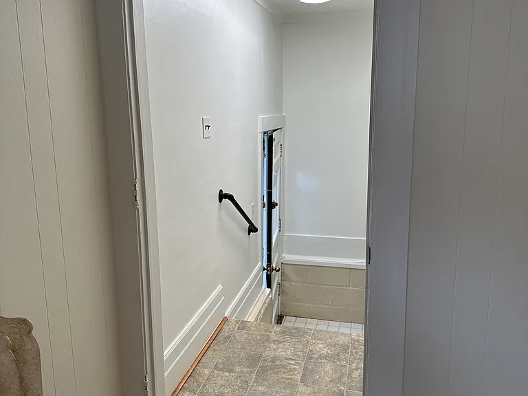 Stairs from kitchen into basement and back yard