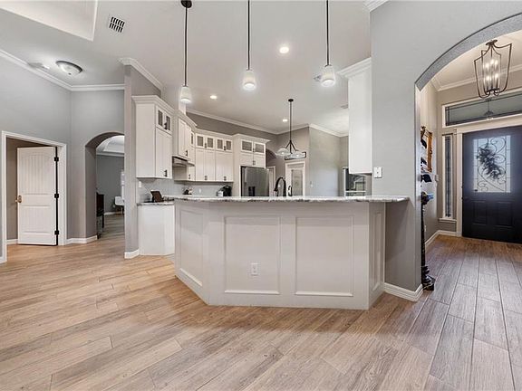 A view of the kitchen, hallway, and an extra room that can be use as office, dining room, another living space for kid's playroom.