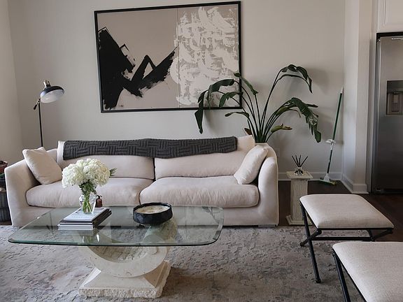 Large Living room with big beautiful windows that allow for plenty of sunlight.