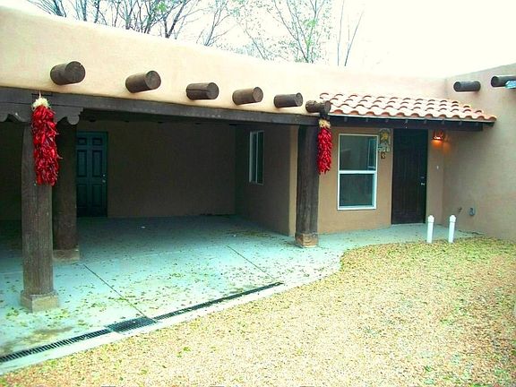 Garage/Covered carport plenty big for a SUV car. Walk way to front door. Nice front area for plants too.