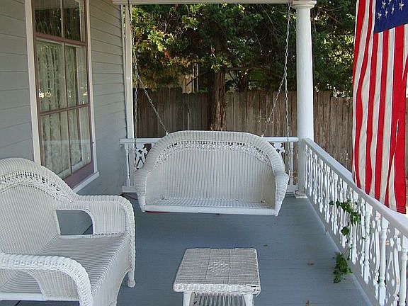 Relax and swing- as you look out onto historic Main St.