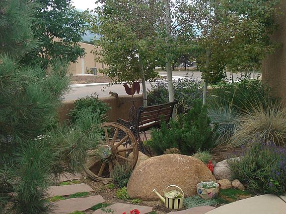 Custom landscaping includes an automatic sprinkler system.
