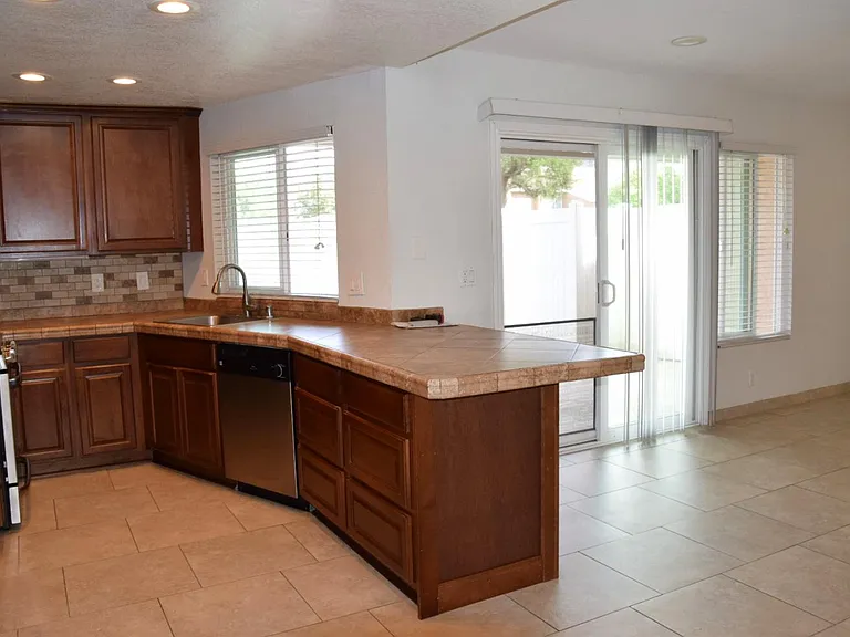kitchen adjacent to dining room and backyard.