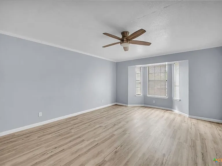 Open concept living area with beautiful bay windows and lots of natural light.