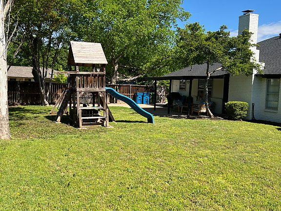 Spacious, fenced backyard with swingset