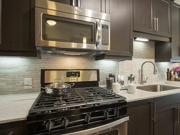Compact kitchen with gas range and clean finishes.