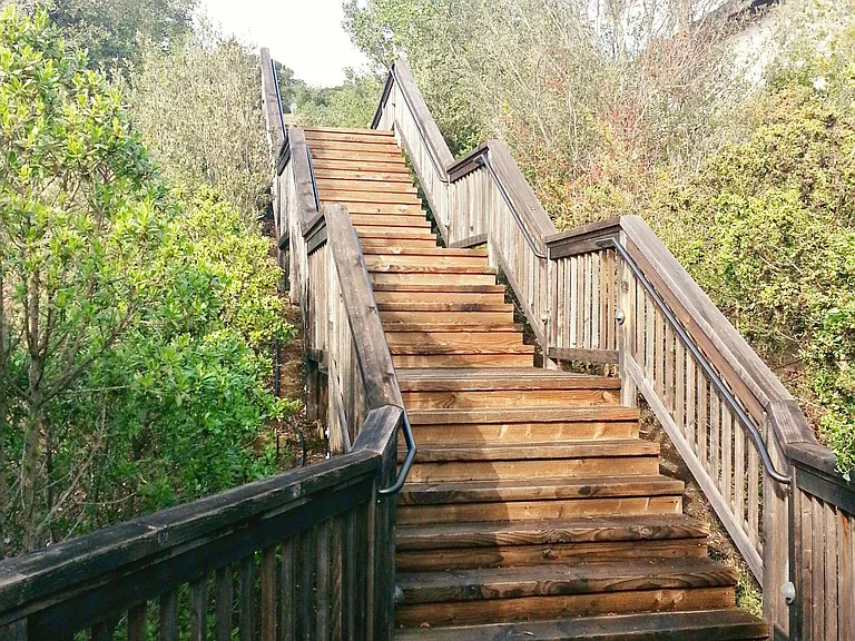 stairs next to house leading up to open space