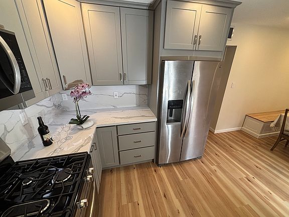 Under cabinet, LED lighting and counter to cabinet, quartz backsplash; lot of electrical outlets