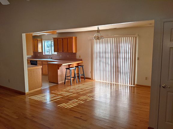 View from front entrance looking at dining area, sliding door to back patio, and kitchen.