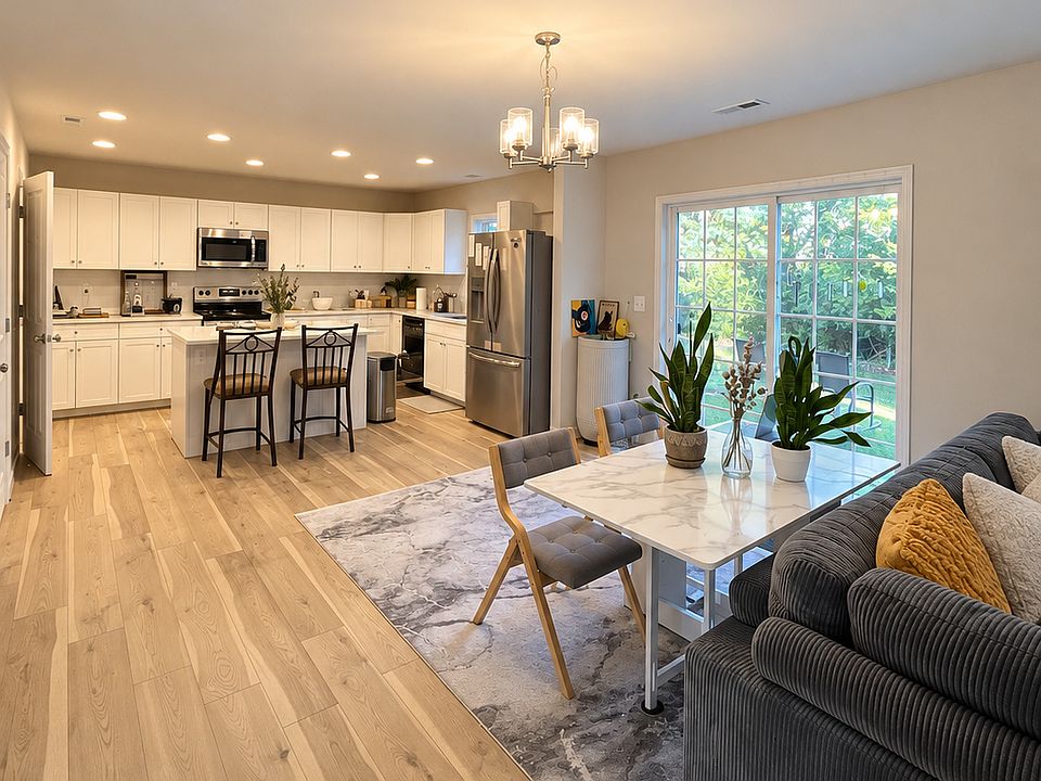 Open living, dining, and kitchen layout with sliding-door access to the backyard.