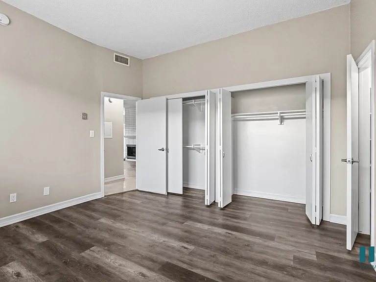 Bedroom with Double Closets and Vinyl Flooring