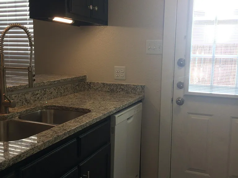 Door in kitchen leads to enclosed back private patio.