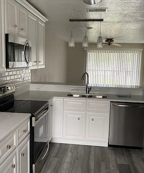 kitchen dishwasher,sink with garbage disposal,microwave and stove