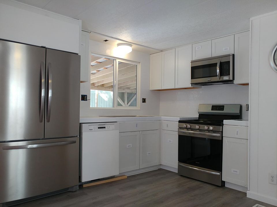 White subway tile backsplash & marble countertops.