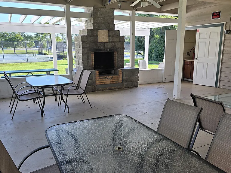 Community center outdoor covered fireplace- events happen here- can be reserved- there is a small kitchen as well