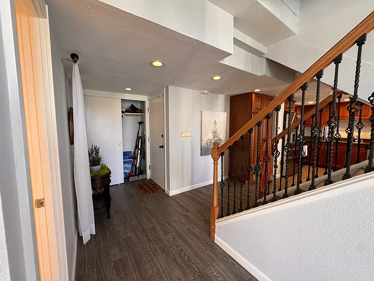 From Left to Right: Bathroom entrance, entrance closet, Entrance door, Kitchen, stairwell in middle
