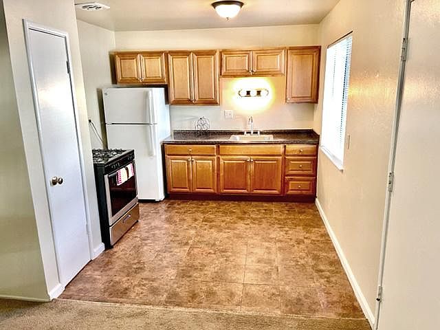 Kitchen with stone countertops, pantry and gas stove