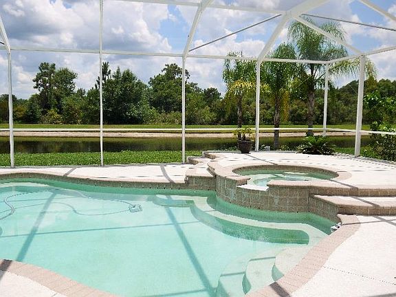 Screened pool with pond and conservation view