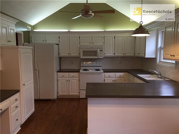 Vaulted Ceiling, new fan and fixtures, pantry cupboard and built in desk area. Cabinets have just been painted.