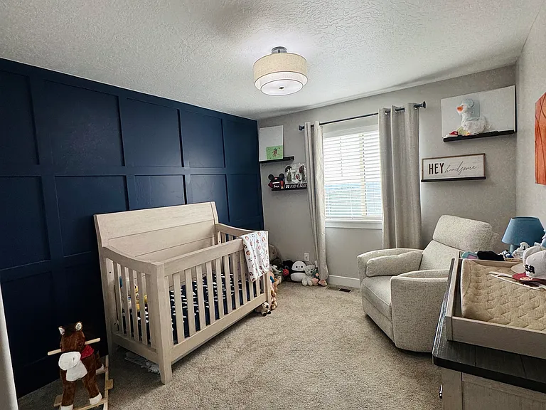 Upstairs Bedroom (navy blue accent wall)