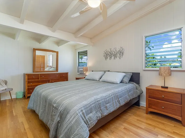 Extra large primary bedroom with Cal King bed and vaulted ceilings.
