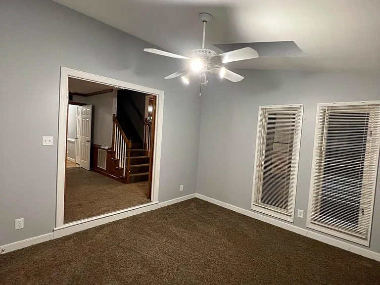 Photo from florida room looking into the living room/stairwell to upstairs