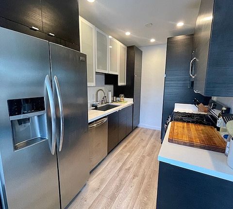 Galley kitchen with all stainless steel appliances