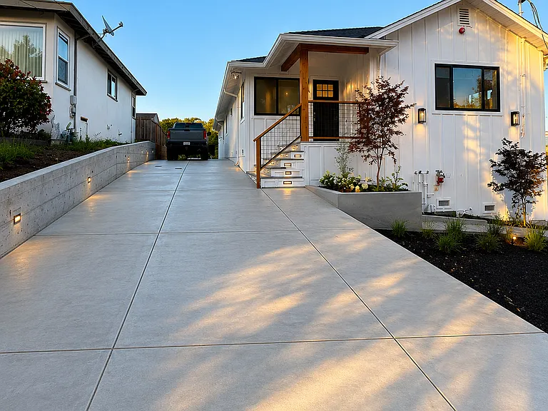 Newly remodeled 4-bedroom home with oversized driveway, attached 2-car garage, and professionally landscaped front yard.
