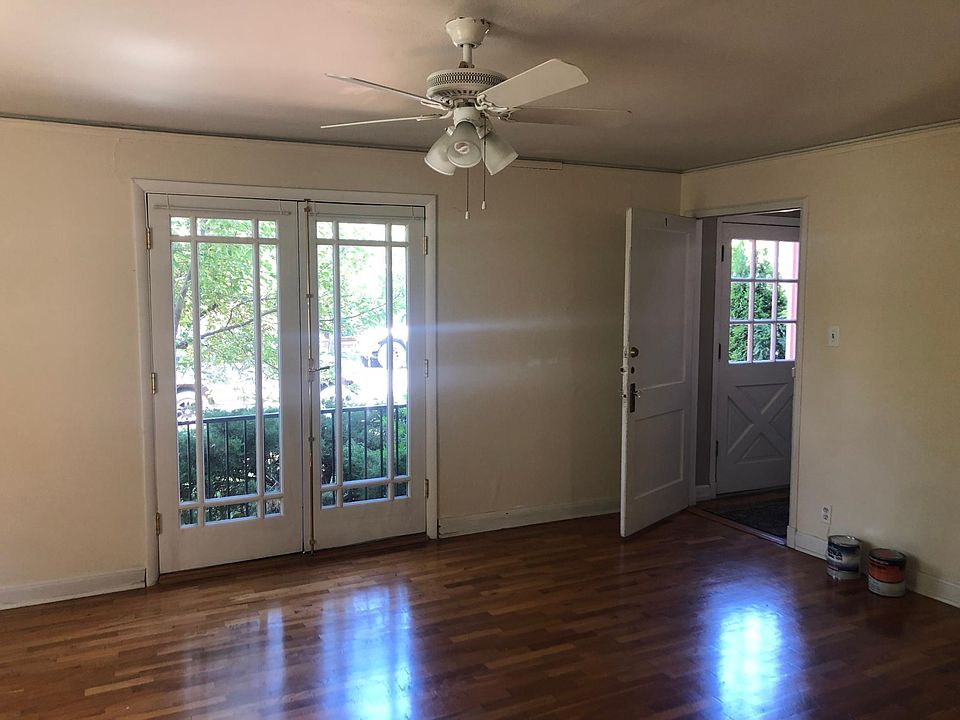 Living room with double doors opening onto front yard or front entry way door opening to hallway.