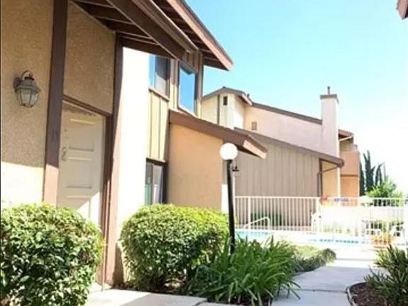 Unit front door. Community Pool is very close to the unit in the background.
