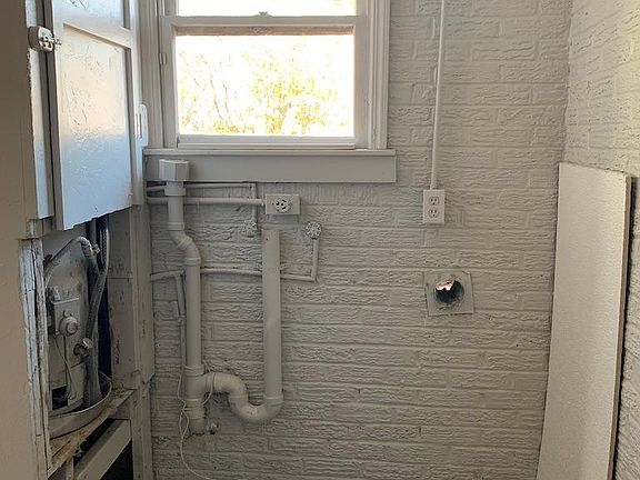 Laundry room with hot water heater and washer dryer connections