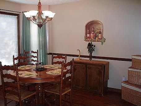 Formal dining room fetures great arched entryways and hardwood floors.