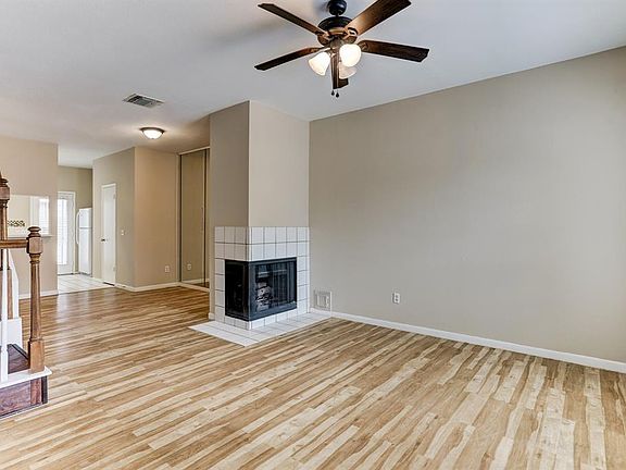 Tiled fireplace separates the dining and living area.