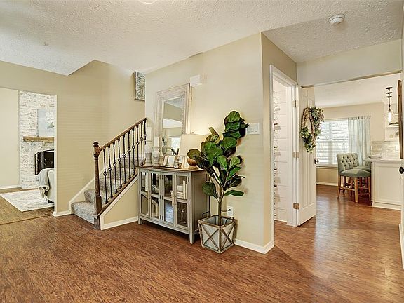 Entry Foyer accessing the Living Room, Wine Closet, Kitchen and Den/Game Room at opposite end